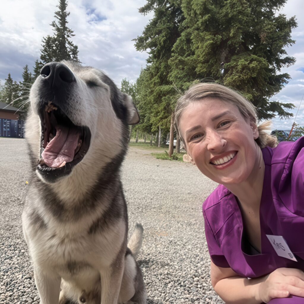 Georgian College Veterinary Technician alumna Kristina Burns takes a selfie with a dog outside.