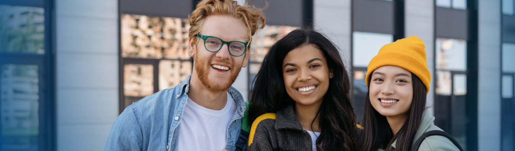 Three students smiling