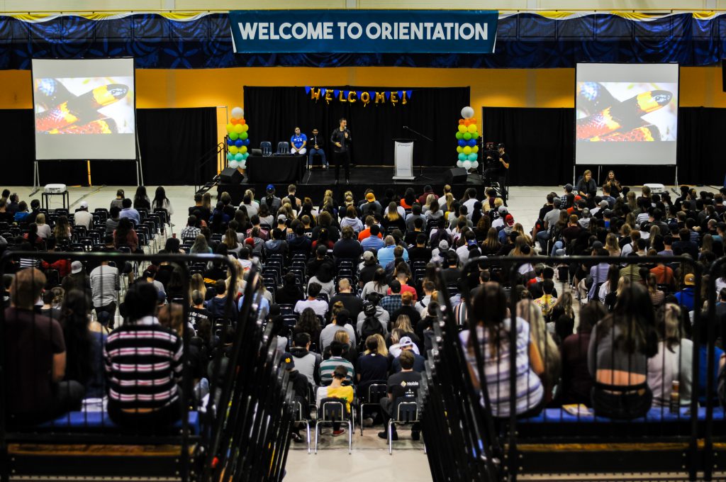 Juan speaking to students during orientation