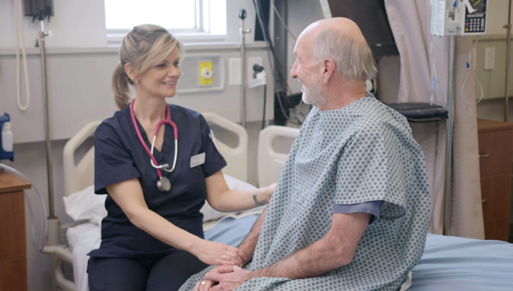 Health, Wellness and Sciences student talking with a patient