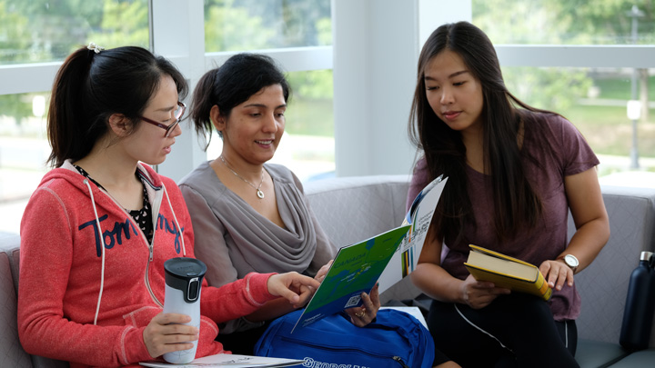 Three students getting help with Academic preparation.
