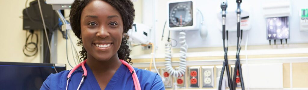Young Black female nurse in scrubs in a college nursing simulation lab.