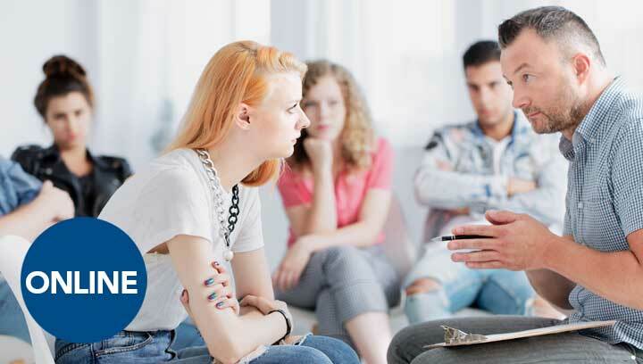 A counsellor provides guidance to a member in recovery at an addictions support group