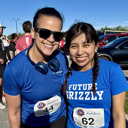A woman and teen participating in the annual Rotary fun run and walk at the Barrie waterfront.