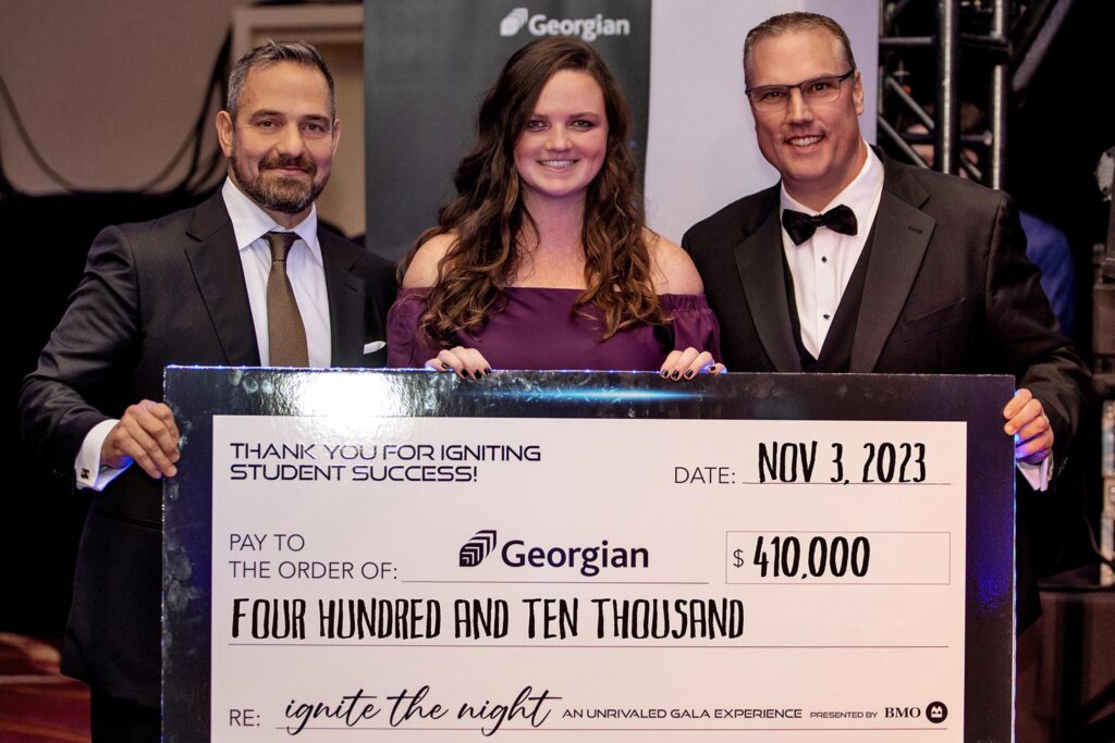 Ali Khonsari, Addison Wallwin and president and CEO Kevin Weaver holding a large cheque at Georgian's Ignite the Night an Unrivaled Gala Experience the amount on the cheque is $410,000