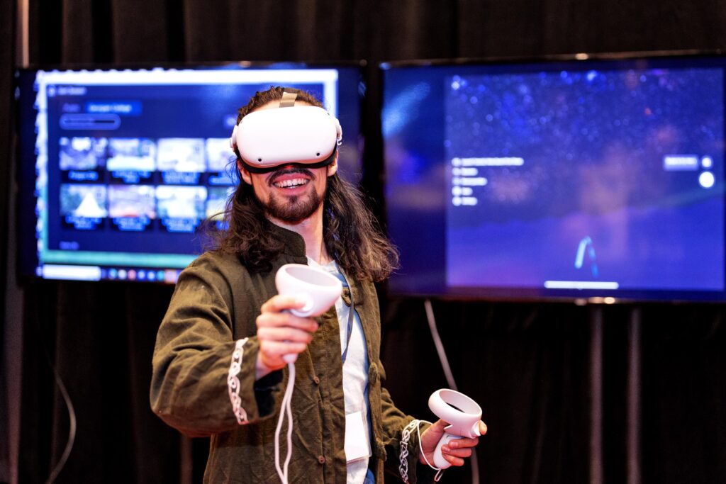 A student demonstrating virtual reality equipment at Georgian's Ignite the Night an Unrivaled Gala Experience.