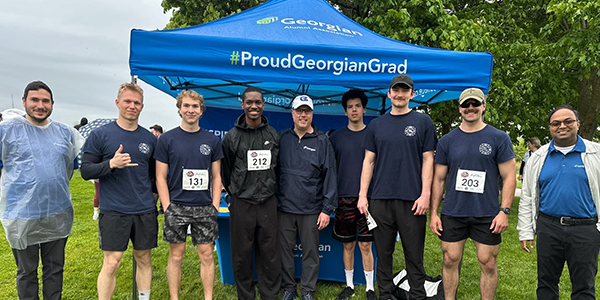 firefighter students and representatives from the alumni association executive council at the rotary fun run and walk event