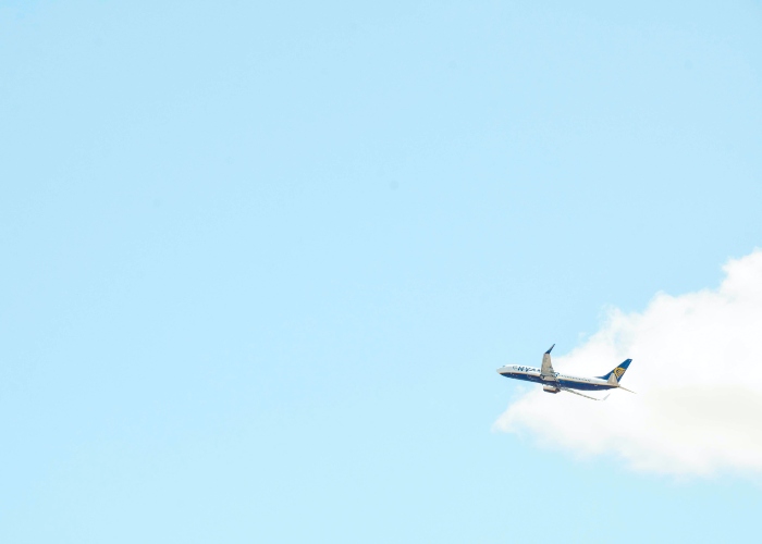 an airplane flying across a blue sky