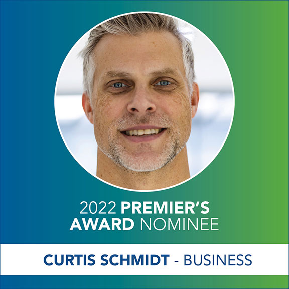 Head shot of a smiling man (Curtis Schmidt) in a circle and the text 2022 Premier's Award Nominee