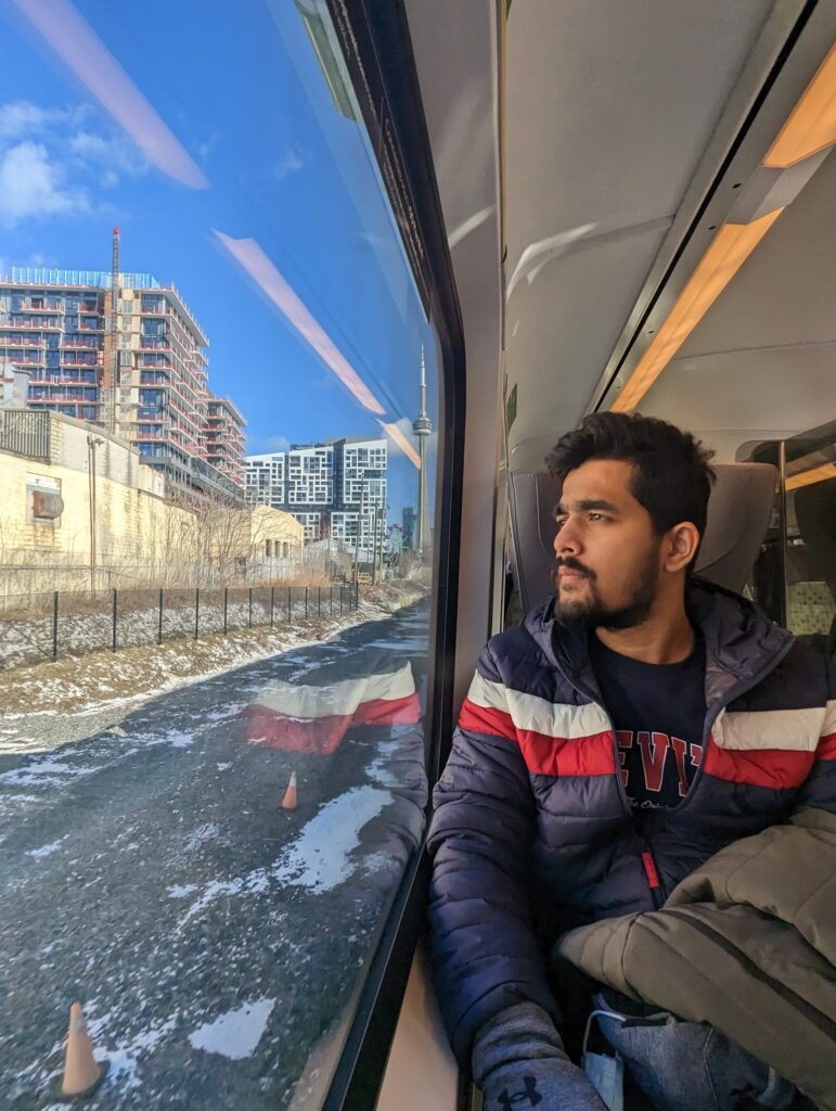 A person sitting on a train looks out the window.