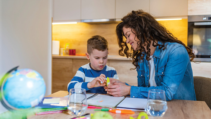 A behavioral analyst working on an activity with a child who has autism in a clinic setting