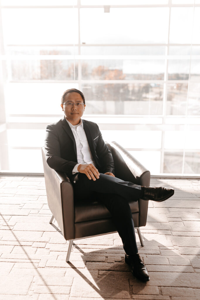 Man in black suit sitting in chair