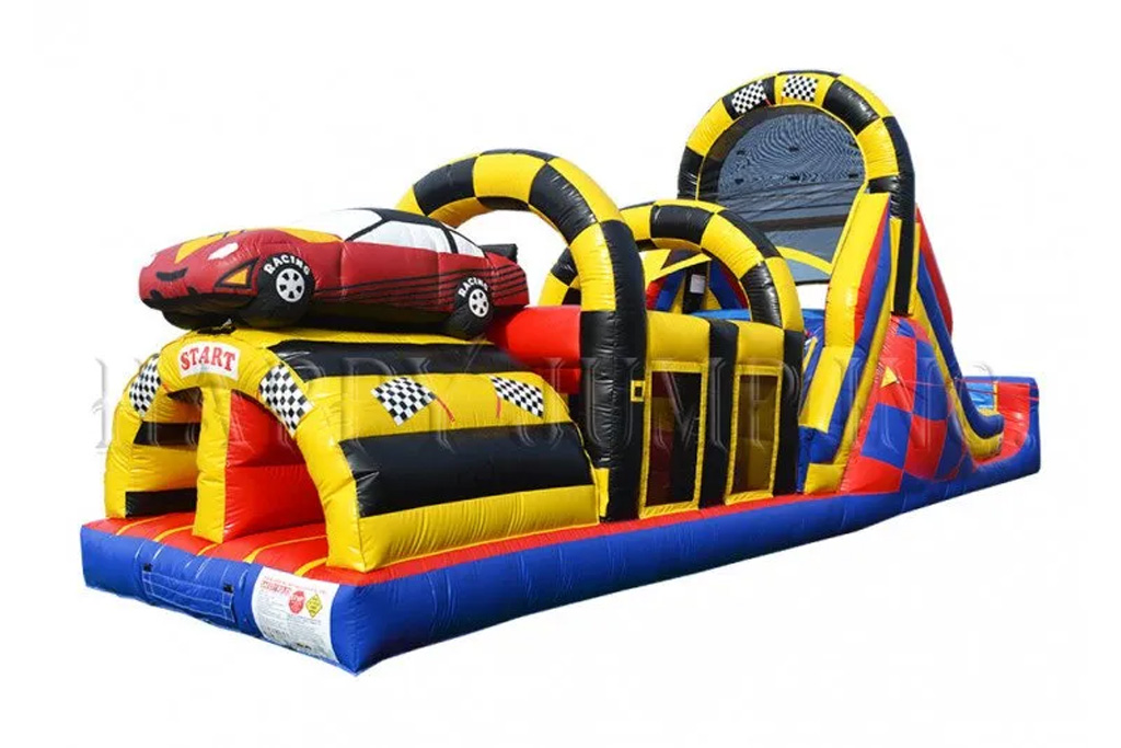 A blue, yellow red and blank inflatable bouncy structure with a red race car and black/white checkered flag accents