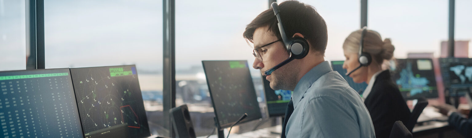 Aviation industry professional sitting in front of flight simulator equipment workstation