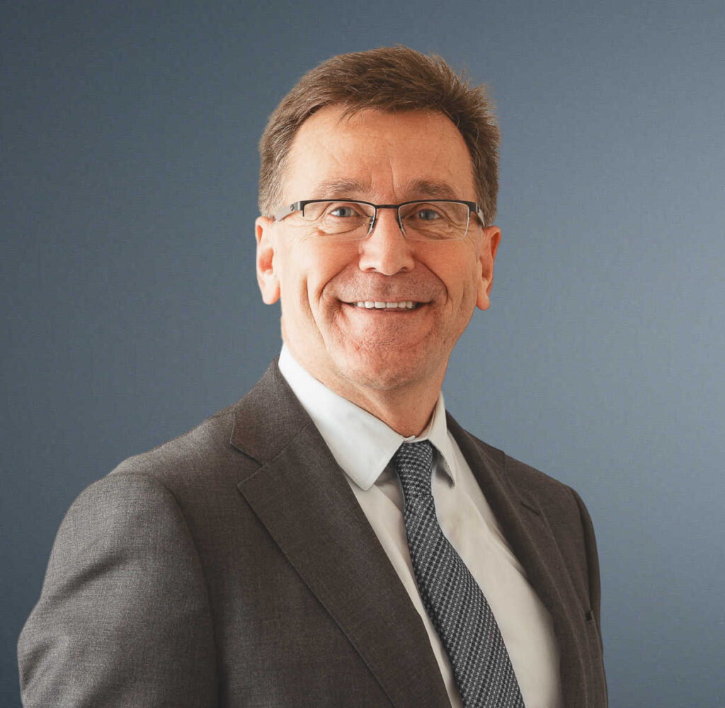 Bill Walker, man with glasses wearing suit and tie, headshot