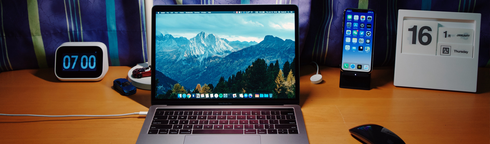 Image of a desk setup for home office. Clock, laptop, phone, To-do list.