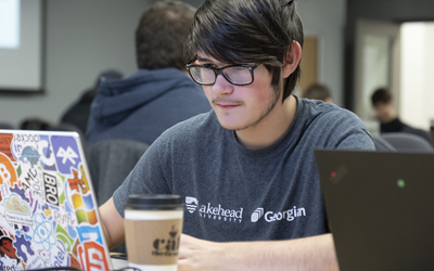 Image of a male student working on laptop