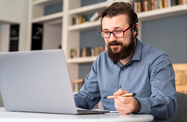 Bearded person using laptop