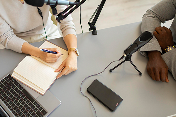 A female faculty taking notes during podcast