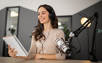 Image of a female podcaster, cover image for "podcasting as a teaching tool" 