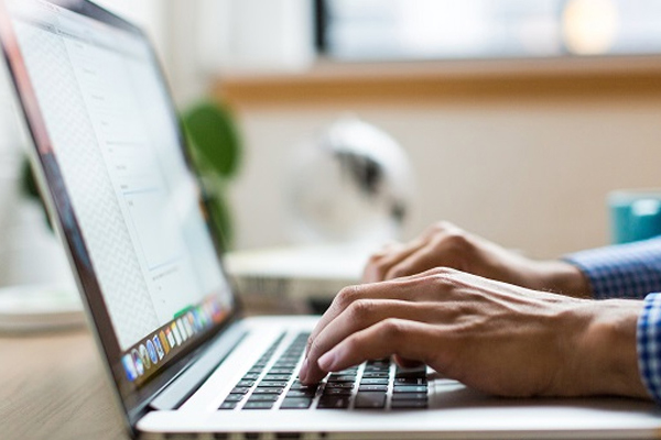 Image of hands typing on keyboard