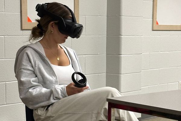 Female wearing VR headset while sitting on chair