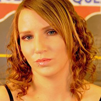 Community and Justice Services graduate Kim Corbett with brown curly hair