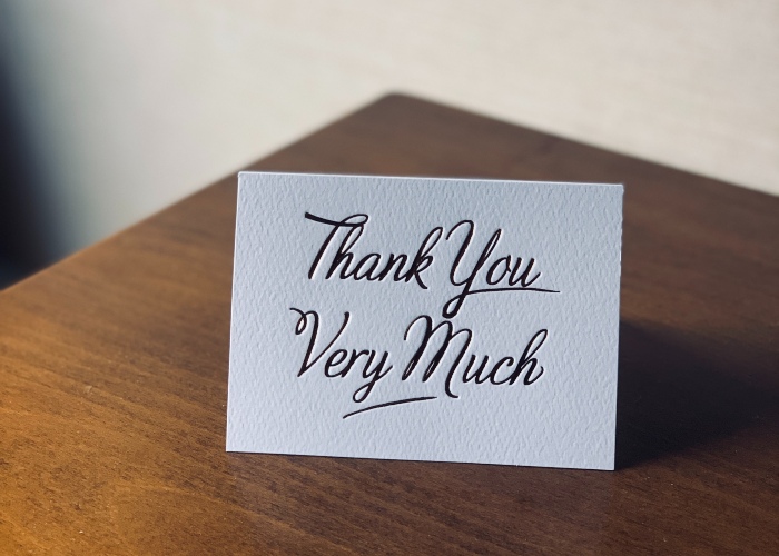a white greeting card that reads "thank you very much"