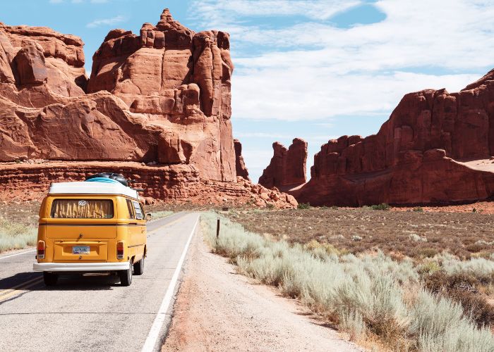 a yellow van driving on a highway