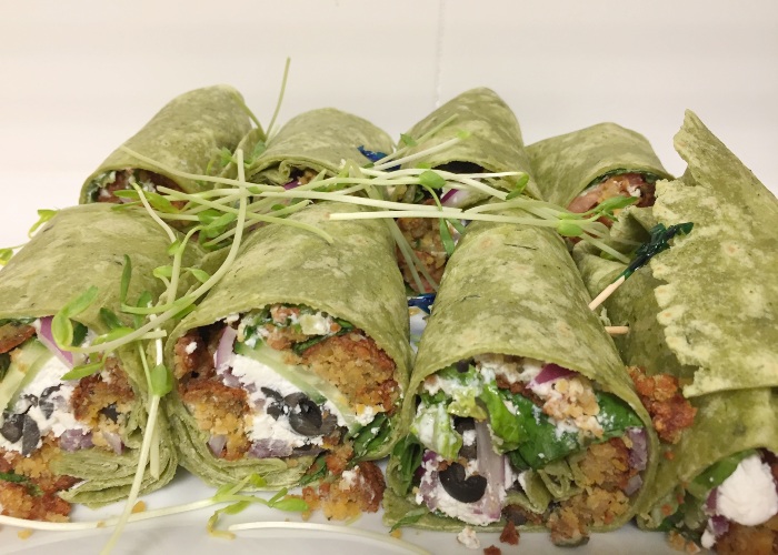 a tray of falafel wraps