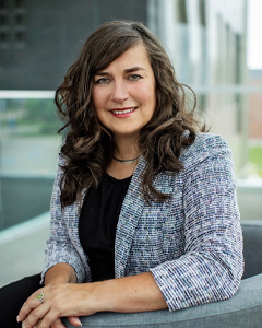 Sheila West, new AVPA, woman with medium-length brown hair, wearing blazer and black shirt sitting down in student lounge at Barrie Campus