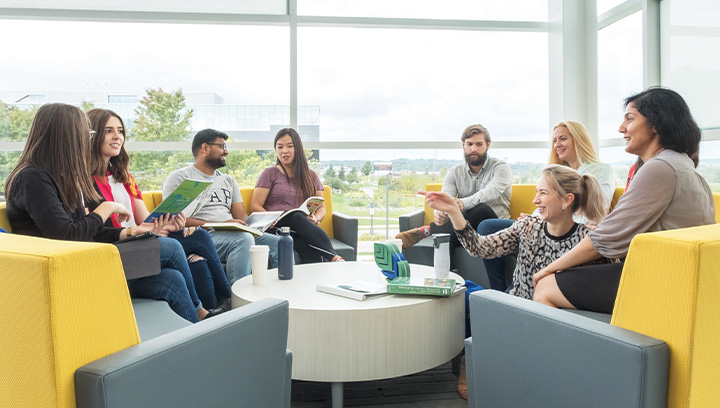 A group of students sitting in the Advanced Technology Centre at Georgian College working on projects