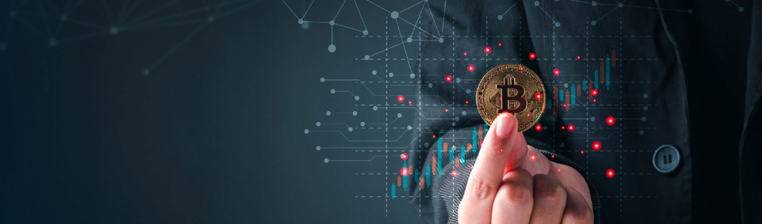 Cryptocurrency and Blockchain Technology specialist in a black suit holding out a gold bitcoin