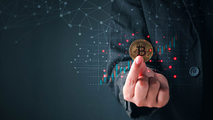 Cryptocurrency and Blockchain Technology specialist in a suit holding out a bitcoin