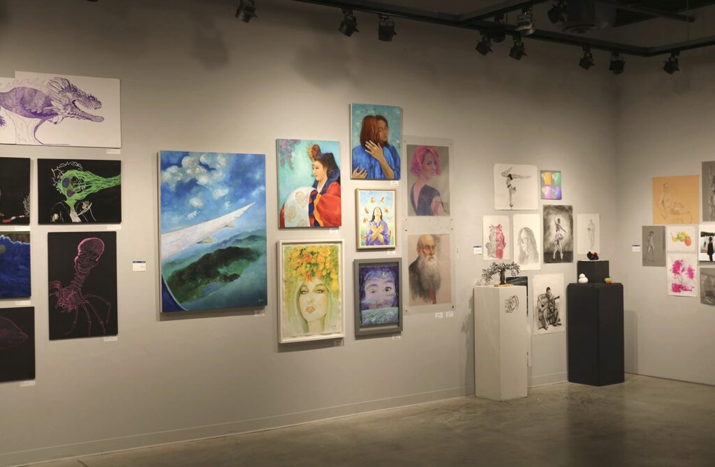 Art displayed on walls in a gallery.