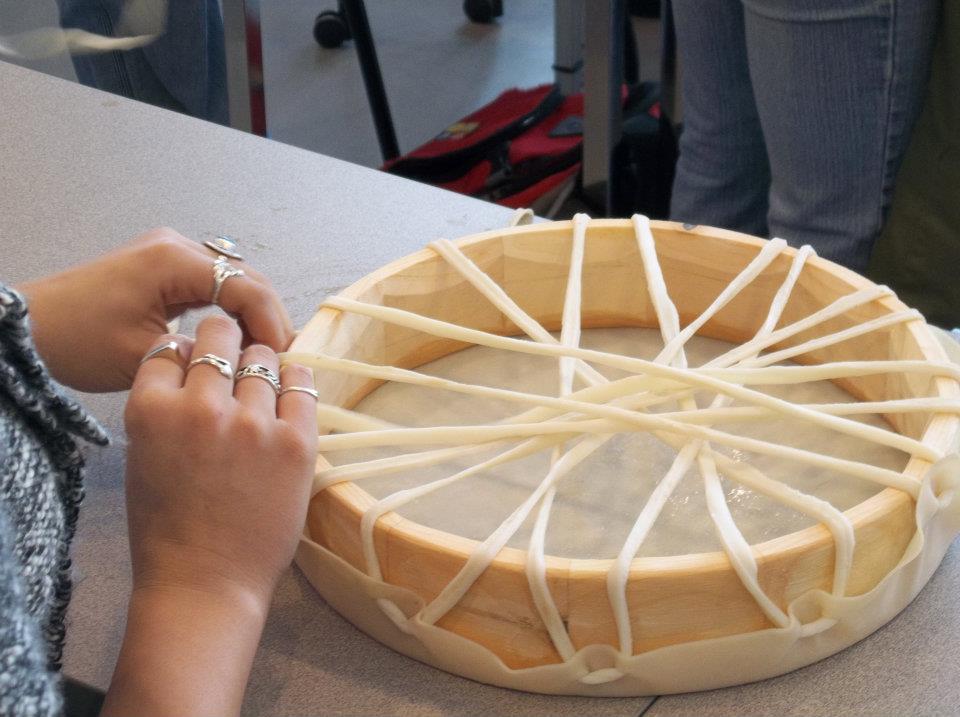 hands making a drum on a craft night in the Indigenous Resource Centre