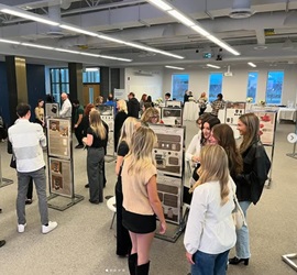 A picture of students and Napoleon representatives looking at submissions in Napoleon Design Contest.