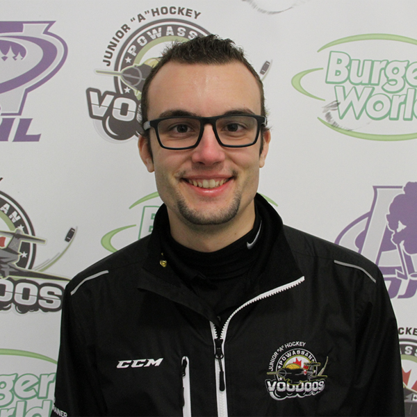 JJ Johnson, Fitness and Health Promotion graduate (class of 2015) smiling with black-framed glasses while wearing a black zip-up athletic jacket branded with CCM and the Powassan Voodies Junior "A" Hockey logos