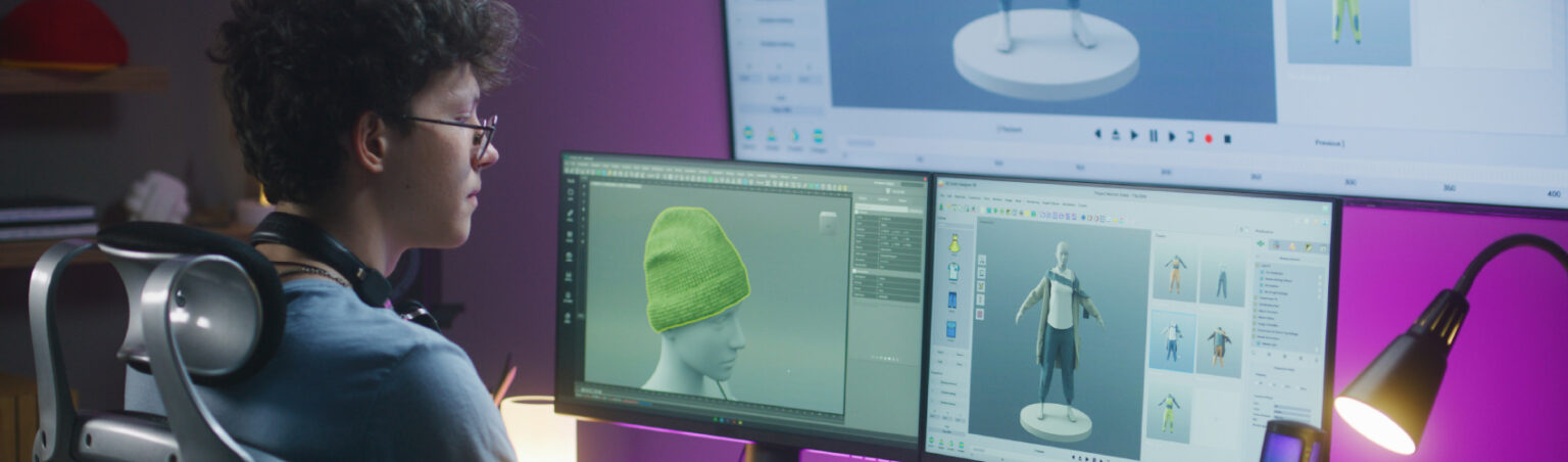 Person sitting at desk, working on a game animation project on two monitors.