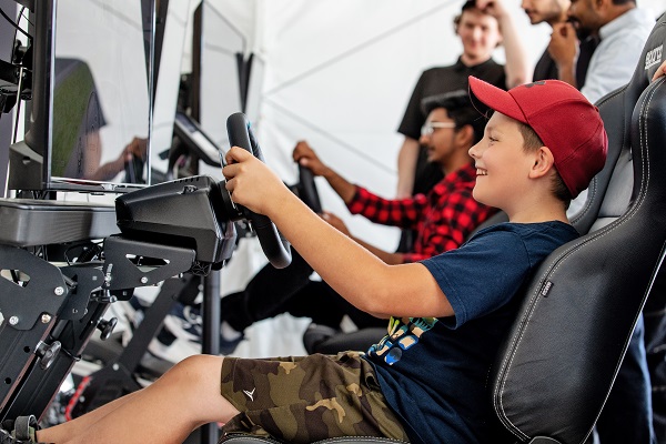 Young boy testing out EV simulator at Georgian College Auto Show