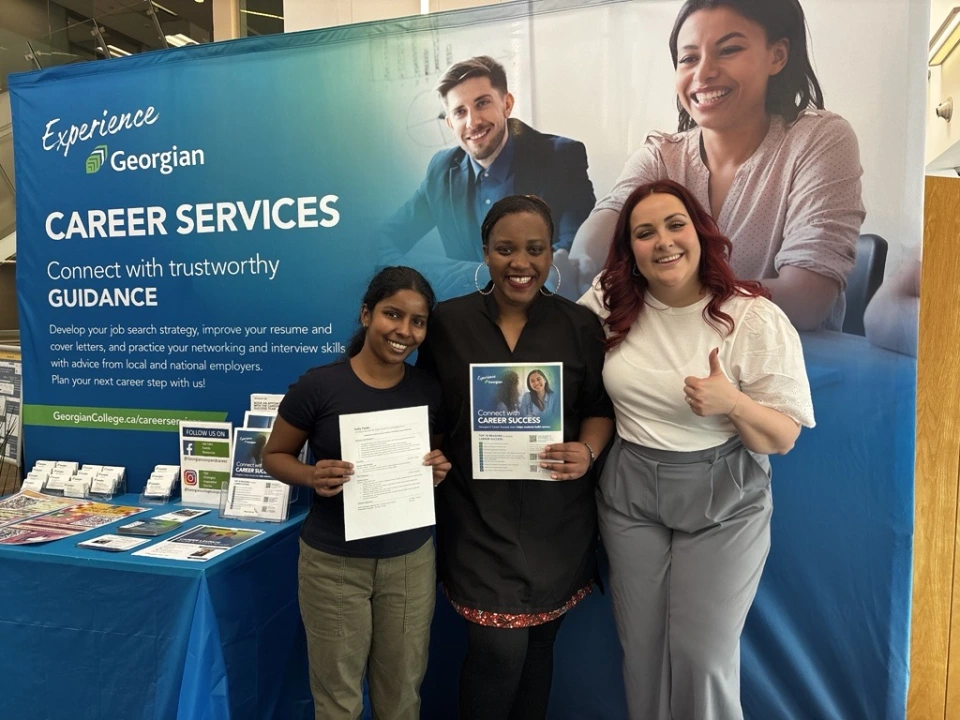 Staff and students stand in front of Georgian's Career Services booth