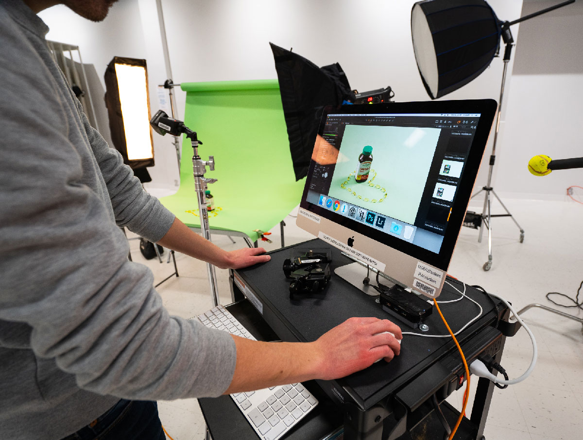 graphic design production student using a computer and editing software