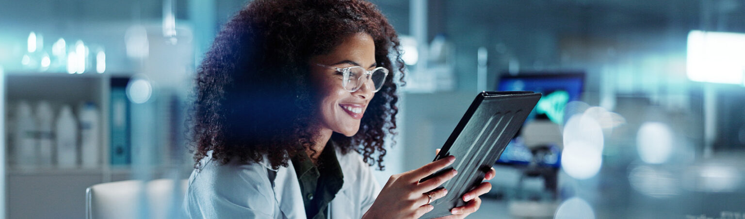 A woman working in a modern facility looking at health information.
