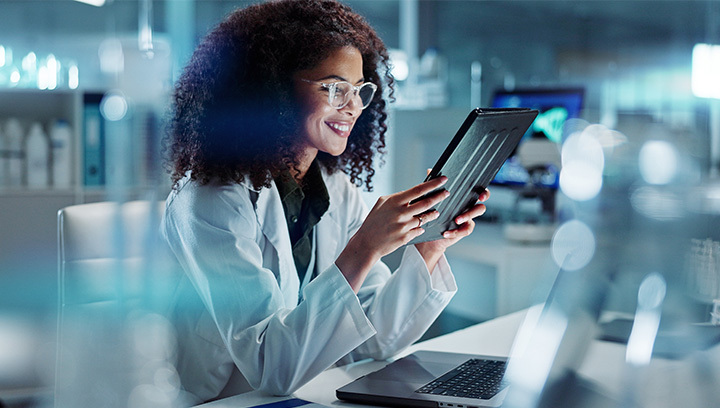 A woman working in a modern facility looking at health information.
