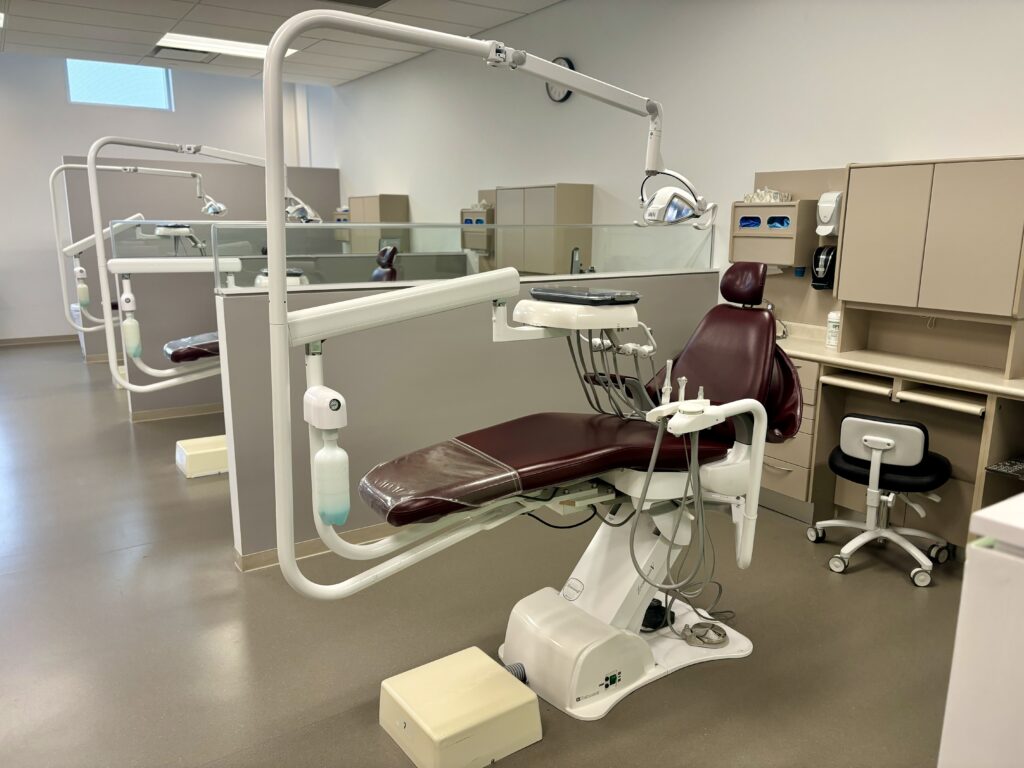 A row with three sections of dental chairs and equipment.