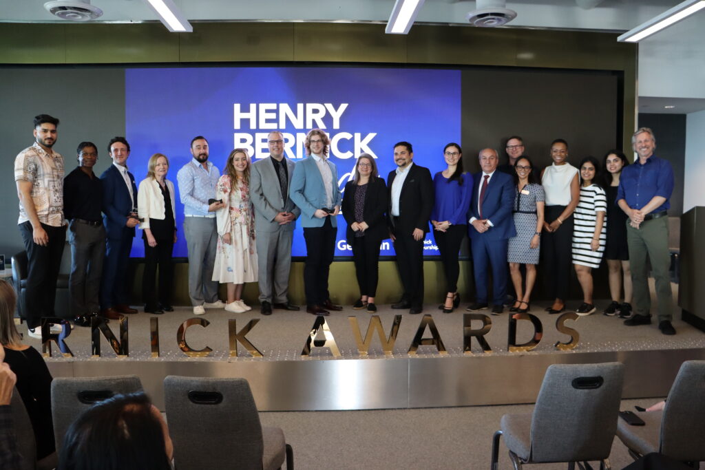 A group of people stand in a row on a stage. Signage reads: Henry Bernick Awards.