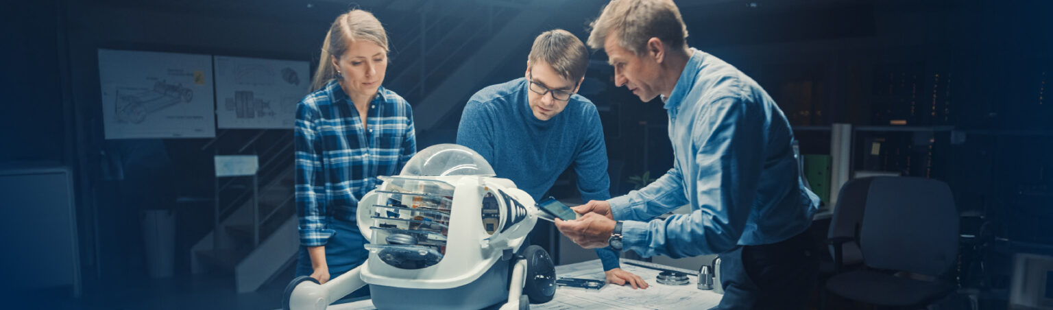 3 people gathered around a device