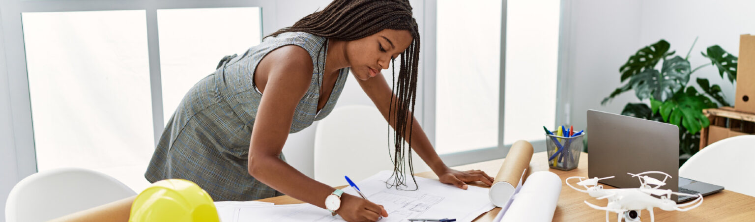 A woman working on housing plans