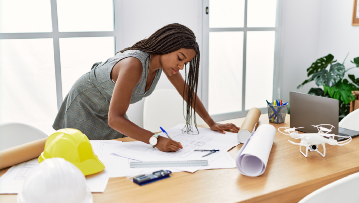 A woman working on housing plans