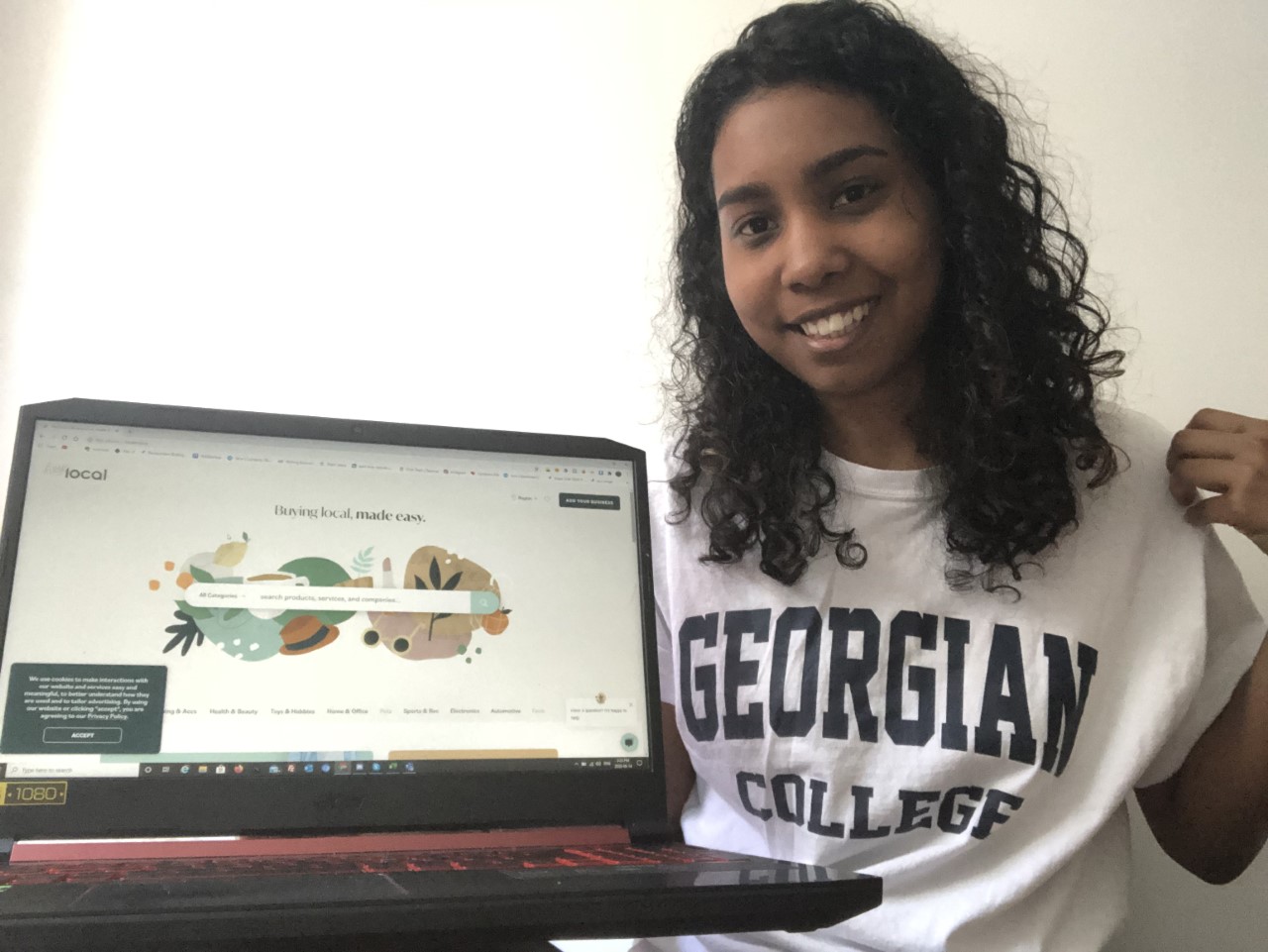 Young woman in Georgian shirt with computer